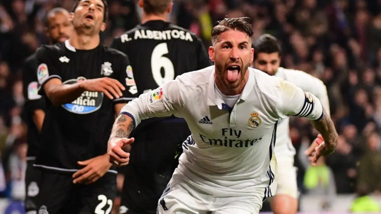 Real Madrid's defender Sergio Ramos celebrates after scoring during the Spanish league football match Real Madrid CF vs RC Deportivo at the Santiago Bernabeu stadium in Madrid on December 10, 2016. / AFP PHOTO / PIERRE-PHILIPPE MARCOU