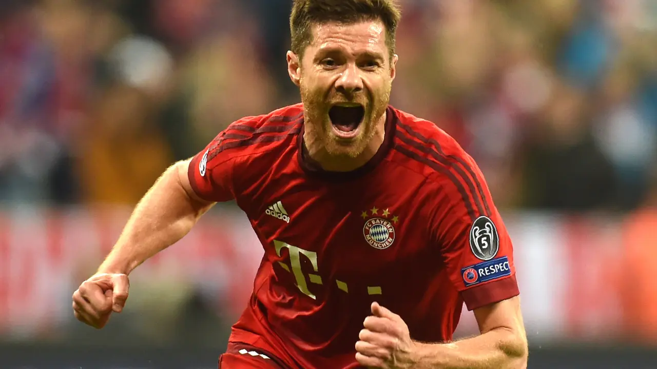 (FILES) This file photo taken on May 03, 2016 shows Bayern Munich's Spanish midfielder Xabi Alonso celebrating scoring during the UEFA Champions League semi-final, second-leg football match between FC Bayern Munich and Atletico Madrid in Munich, southern Germany.
Bayern Munich's Spanish midfielder Xabi Alonso announced on March 9, 2017 thta he will end his football career at the end of the current season. / AFP PHOTO / Christof Stache