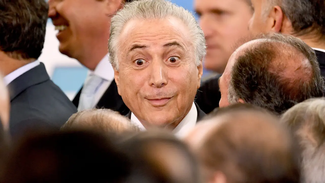 Brazilian President Michel Temer gestures during the swearing in ceremony of his new ministers of Justice and Foreign Affairs, at Planalto Palace in Brasilia, on March 7, 2017. / AFP PHOTO / EVARISTO SA