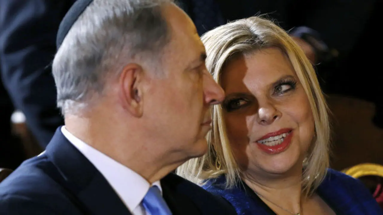 FILE - In this Dec. 1, 2013 file photo, Prime Minister Benjamin Netanyahu listens to his wife Sara during a meeting with the Roman Jewish Community at the Great Synagogue in Rome. With Israeli elections looming and the region in turmoil, Netanyahu found himself once more enmeshed in a gossipy scandal on Tuesday: Israel's government watchdog released a report into alleged financial malfeasance at the prime minister's residence, while his wife faced criticism for pettiness and possible security breaches after complaining in a video about the shabbiness of the kitchen at their official Jerusalem residence. (AP Photo/Riccardo De Luca, File)