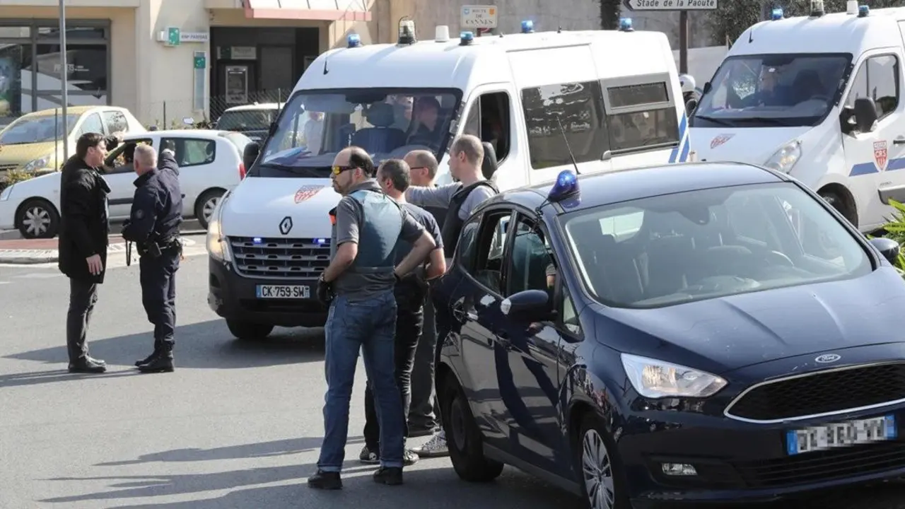 Policemen stand near police vehicles in the southern French town of Grasse  on March 16  2017 following a shooting in the Tocqueville high school that left two people injured  At least two people were injured in a shooting at a high school in the southern French town of Grasse on March 16  2017 which saw the head teacher targeted  police and local authorities said  One 17-year-old pupil armed with a rifle  two handguns and two grenades was arrested after the shooting at the Tocqueville high school  a police source told AFP  asking not to be named     AFP PHOTO   Valery HACHE