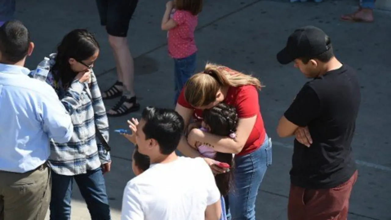 A woman hugs a girl after she and other North Park Elementary School students were released to their guardians following a shooting at the school which left two adults and one child dead, April 10, 2017 at Cajon High School in San Bernardino California.  
A gunman opened fire at an elementary school in the California city of San Bernardino, killing one woman and wounding two students before turning the gun on himself, police said. The students were airlifted to a local hospital where their conditions were described as critical.
 / AFP PHOTO / Robyn Beck