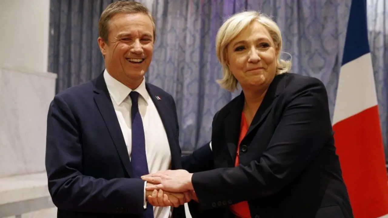 Former French presidential election candidate for the right-wing Debout la France (DLF) party Nicolas Dupont-Aignan (L) and French presidential election candidate for the far-right Front National (FN) party Marine Le Pen, shake hands at the end of a joint statement at FN headquarters in Paris, on April 29, 2017.
Dupont-Aignan, who arrived on the sixth position with 4.7% of the votes during the first round of the presidential election, announced on April 28, 2017 that "he endorses" Marine Le Pen for the second round of the election. The candidate of the FN declared that she will appoint Dupont-Aignan as Prime minister if she will be elected. / AFP PHOTO / GEOFFROY VAN DER HASSELT