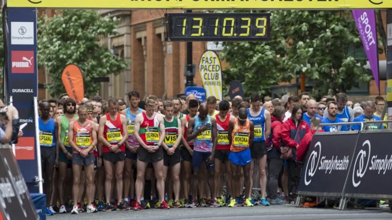 Elite runners observe a minute of silence for the victims of the Manchester Arena bombing before the start of the Great Manchester Run in Manchester, north west England on May 28, 2017. 
Britain police have released CCTV footage of Manchester bomber Salman Abedi on the night of the attack as thousands defied the terror threat to take part in the Great Manchester Run on Sunday. / AFP PHOTO / JON SUPER