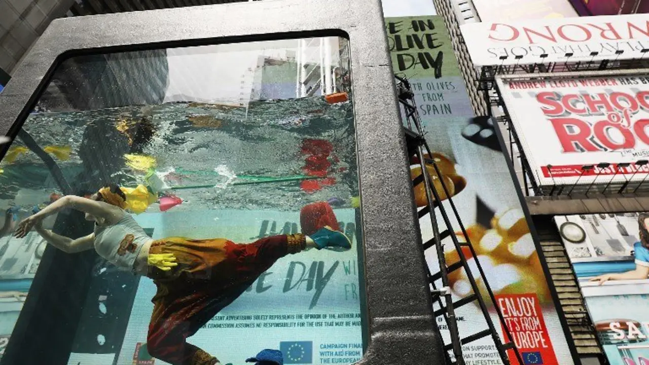 NEW YORK, NY - MAY 31: Performance artist Annie Saunders performs in Times Square in Holoscenes, a tank that rapidly fills with water and engulfs the performer, as part of the World Science Festival on May 31, 2017 in New York City. As part of the tenth World Science Festival, Holoscenes developed out of a concern that water from itensifying floods, rising seas, and longer droughts will be a central issue of the 21st century. Holoscenes is performed in a twelve ton glass aquarium and will be performed from 6pm to 11pm, June 1 - 3.   Spencer Platt/Getty Images/AFP