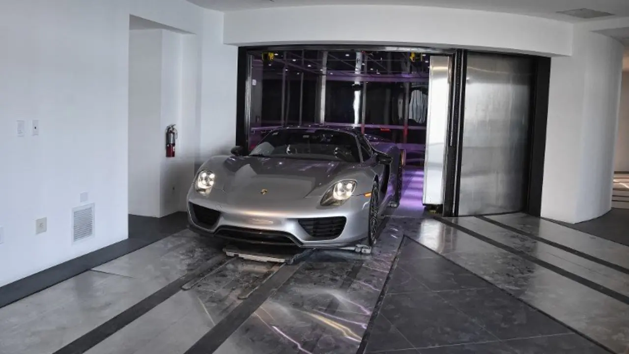 A Porsche arrives in a condo in the automated car elevator in the Porsche Design Tower on Sunny Isles Beach, Florida, on May 9, 2017.

The luxury condominiums are the only one of their kind with a patented car elevator known as the Dezervator, named for Developer Gil Dezer, allowing you to park you vehicle inside your home. / AFP PHOTO / RHONA WISE
