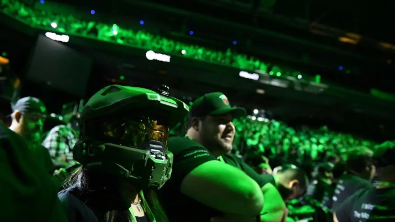 An attendee wears the helmet of Master Chief from the original Halo at the Microsoft Xbox E3 2017 Briefing, June 11, 2017 at the Galen Center in Los Angeles, California. 
The Electronic Entertainment Expo (E3), which focuses on new products and technologies in electronic gaming systems and interactive entertainment, takes places June 13-15 at the Los Angeles Convention Center. / AFP PHOTO / Robyn BECK