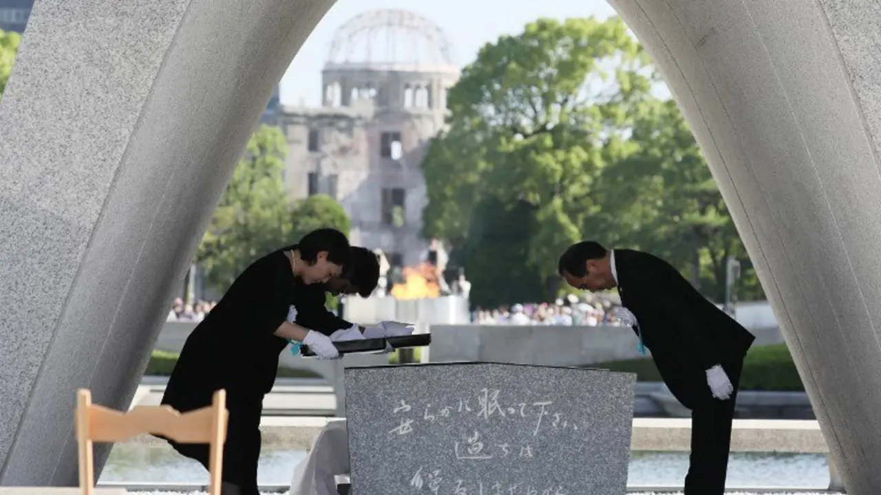 Hiroshima Mayor Kazumi Matsui (R) offers a new list of A-bomb dead, people who died since last year's anniversary from the side effects of radiation, during the 72nd anniversary memorial service for the atomic bomb victims at the Peace Memorial Park in Hiroshima on August 6, 2017.
A US B-29 plane dropped a bomb over the city at 8:15am on August 6, 1945, marking the first use of an atomic weapon which ultimately claimed the lives of some 140,000 people. / AFP PHOTO / JIJI PRESS / STR / Japan OUT