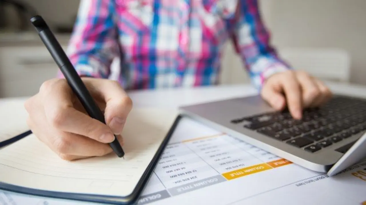 persona-de-negocios-trabajando-en-la-computadora-portatil-y-haciendo-notas_1262-3150