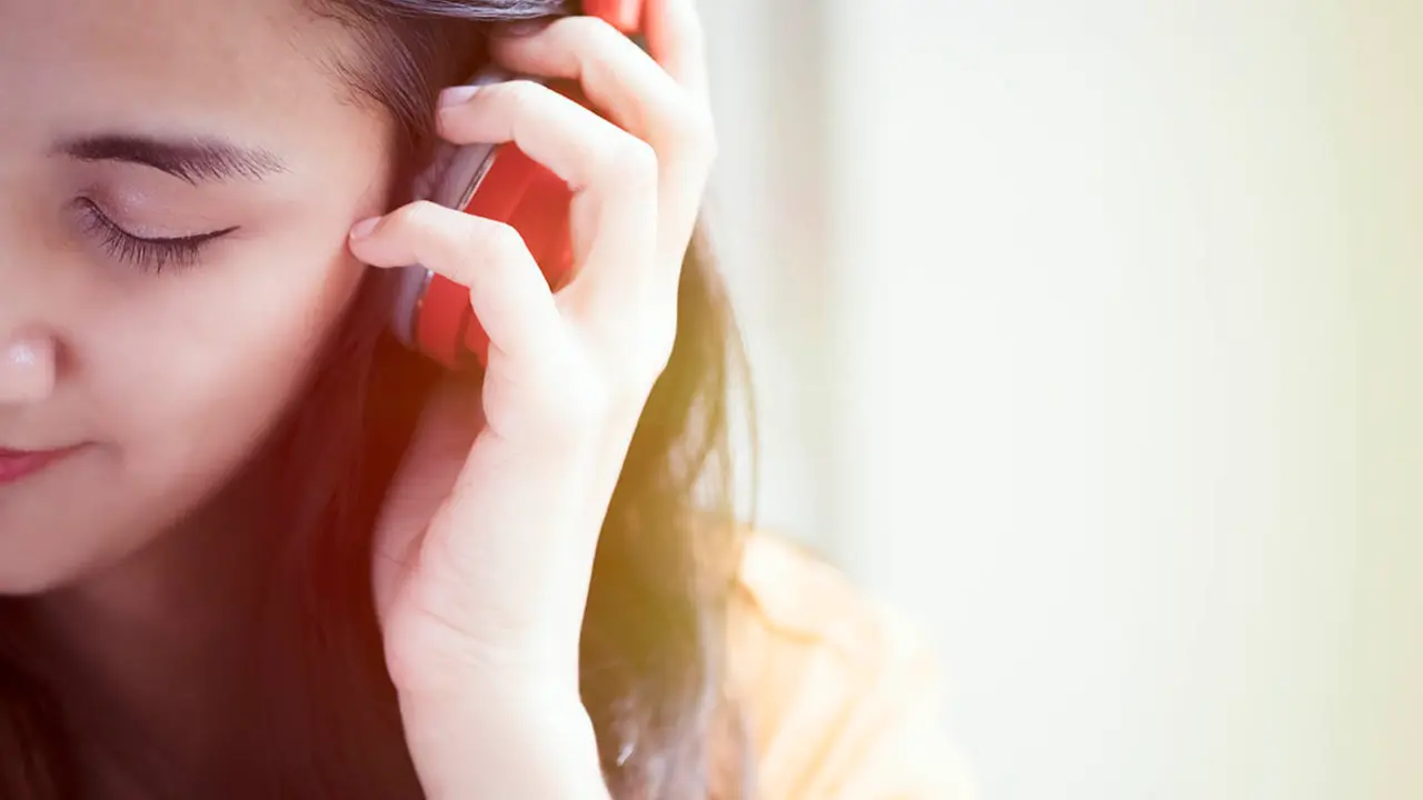 Young beautiful woman enjoying the music. Hobby and relax concept idea background.