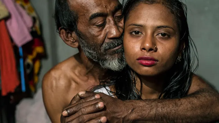 Kajol with a customer. She thinks she is 17 years but does not know her exact age. She was married with 9 years. Her aunt sold her to the Kandapara brothel. She has a 6 month son, Mehedi. Two weeks after the birth she was forced to have sex again with customers. Because of the baby her business is not so good.
