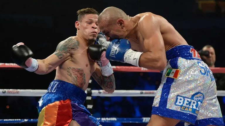 LAS VEGAS, NV - OCTOBER 12: Orlando Salido (R) lands a right to the head of Orlando Cruz during their WBO featherweight championship bout at the Thomas & Mack Center on October 12, 2013 in Las Vegas, Nevada.   Jeff Bottari/Getty Images/AFP