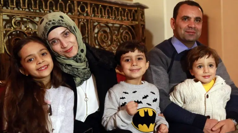 Syrian girl Bana al-Abed (L), known as Aleppo's tweeting girl, poses with her family, her mother Fatemah, her father Ghassan and her brothers Nour (C) and Laith (R) during an interview in Ankara, Turkey, on December 22, 2016. 
The young Syrian girl was one of thousands of people evacuated from once rebel-held areas of Aleppo in the last days under a deal brokered by Turkey and Russia. She was evacuated on Monday and Turkish officials promised then she would come to Turkey with her family. But it was not clear when she had crossed over. / AFP PHOTO / ADEM ALTAN