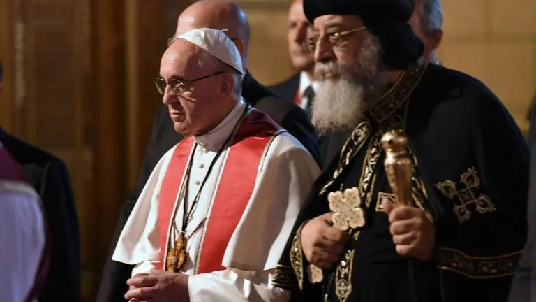Pope Francis (L) walks alongside Coptic Pope Tawadros II (R) during a visit at the Saint Peter and Saint Paul church in Cairo, which was target by a suicide bomb attack that killed 29 people last December, on April 28, 2017
Francis, who started a two-day visit, has said he hoped his trip would contribute to dialogue with Muslims and show support for Egypt's Coptic Christians.  / AFP PHOTO / Andreas SOLARO