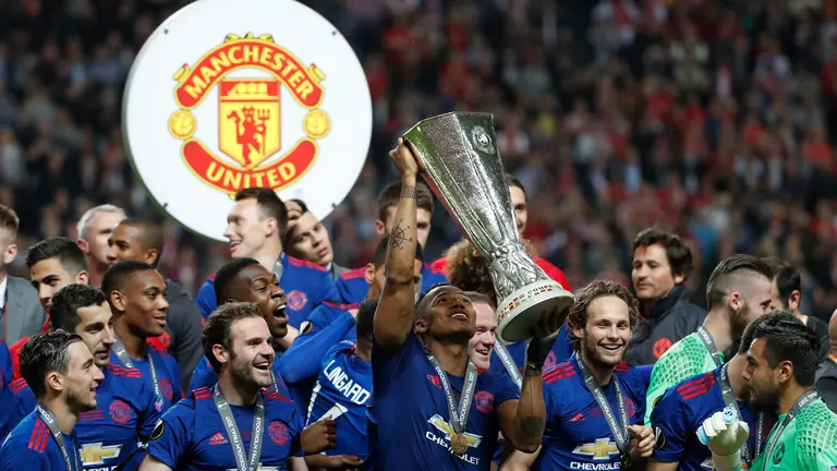 Manchester United's players including Ecuadorian midfielder Antonio Valencia (C) celebrate with the trophy after the UEFA Europa League final football match Ajax Amsterdam v Manchester United on May 24, 2017 at the Friends Arena in Solna outside Stockholm. / AFP PHOTO / Odd ANDERSEN