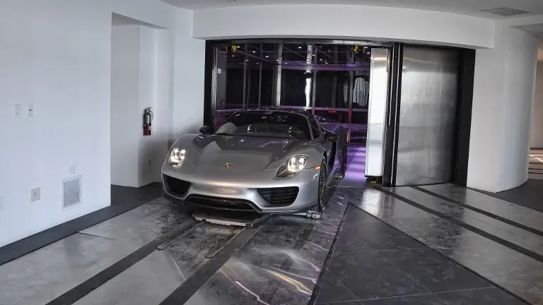 A Porsche arrives in a condo in the automated car elevator in the Porsche Design Tower on Sunny Isles Beach, Florida, on May 9, 2017.

The luxury condominiums are the only one of their kind with a patented car elevator known as the Dezervator, named for Developer Gil Dezer, allowing you to park you vehicle inside your home. / AFP PHOTO / RHONA WISE