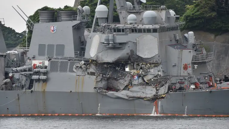 This photo shows damages on the guided missile destroyer USS Fitzgerald at its mother port in Yokosuka, southwest of Tokyo on June 18, 2017. 
A number of missing American sailors have been found dead in flooded areas of a destroyer that collided with a container ship off Japan's coast, the US Navy said on June 18, 2017. / AFP PHOTO / Kazuhiro NOGI