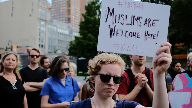 NEW YORK, NY - JUNE 29: Recent Immingrants join activists for an evening protest in Manhattan hours before a revised version of President Donald Trump's travel ban that was approved by the Supreme Court is to take effect on June 29, 2017 in New York City. Hundreds of protesters marched through the streets demanding and end to the ban which prohibits for 90 days the entry of travellers from six predominantly Muslim countries: Iran, Libya, Somalia, Sudan, Syria and Yemen. The court granted an exception for people with 'bona fide relationships' in the United States.   Spencer Platt/Getty Images/AFP