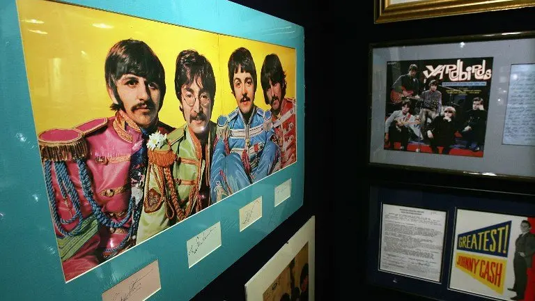 Beatles memorabilia stands on display at Christie's 10 December  2004 in New York City. Christie's, in a partnership with Julien's, will hold a Rock & Roll and Entertainment Memorabilia auction Friday, 17 December  2004. The sale, which will include such items as guitars owned by Beatle George Harrison, an Academy Award from 1941 for Best Picture, interview tapes of John Lennon, letters from Kurt Cobain to Courtney Love and numerous Elvis memorabilia, is expected to realize in the region of $3 million.  (Photo by Spencer Platt/Getty Images/AFP)  FOR NEWSPAPERS AND TV USE ONLY  --  MORE IMAGES AVAILABLE ON IMAGEFORUM