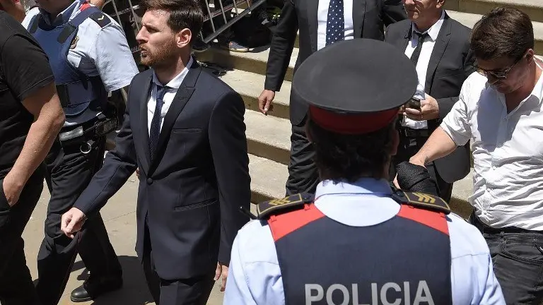 (FILES) This file photo taken on June 2, 2016 shows 
Barcelona's football star Lionel Messi (L), followed by his father, leaving the courthouse in Barcelona.
A Spanish court said today it has replaced with fines the suspended prison sentences handed down to FC Barcelona's star striker Lionel Messi and his father. / AFP PHOTO / LLUIS GENE