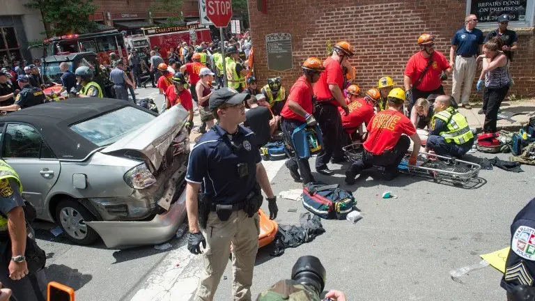 (FILES) This file photo taken on August 12, 2017 shows a woman  receiving first-aid after a car accident ran into a crowd of protesters in Charlottesville, Virginia.
A suspected white supremacist's attack on a crowd of protesters using his car as a battering ram fits the definition of domestic terrorism, US Attorney General Jeff Sessions said August 14, 2017. A woman was killed and 19 people were injured when the car plowed into a crowd of people Saturday in Charlottesville, Virginia after a violent rally by neo-Nazis and white supremacists protesting the removal of a Confederate statue.The vehicle attack "does meet the definition of domestic terrorism in our statute," Sessions said in an interview on ABC's Good Morning America program.
 / AFP PHOTO / PAUL J. RICHARDS