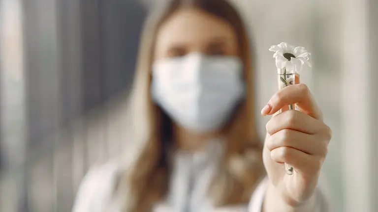 Medical student at the hall. Woman in a white uniform. Doctor in masks. Coronavirus theme.