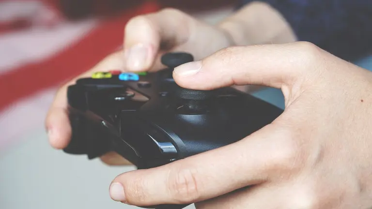 man-holding-black-game-controller-133579