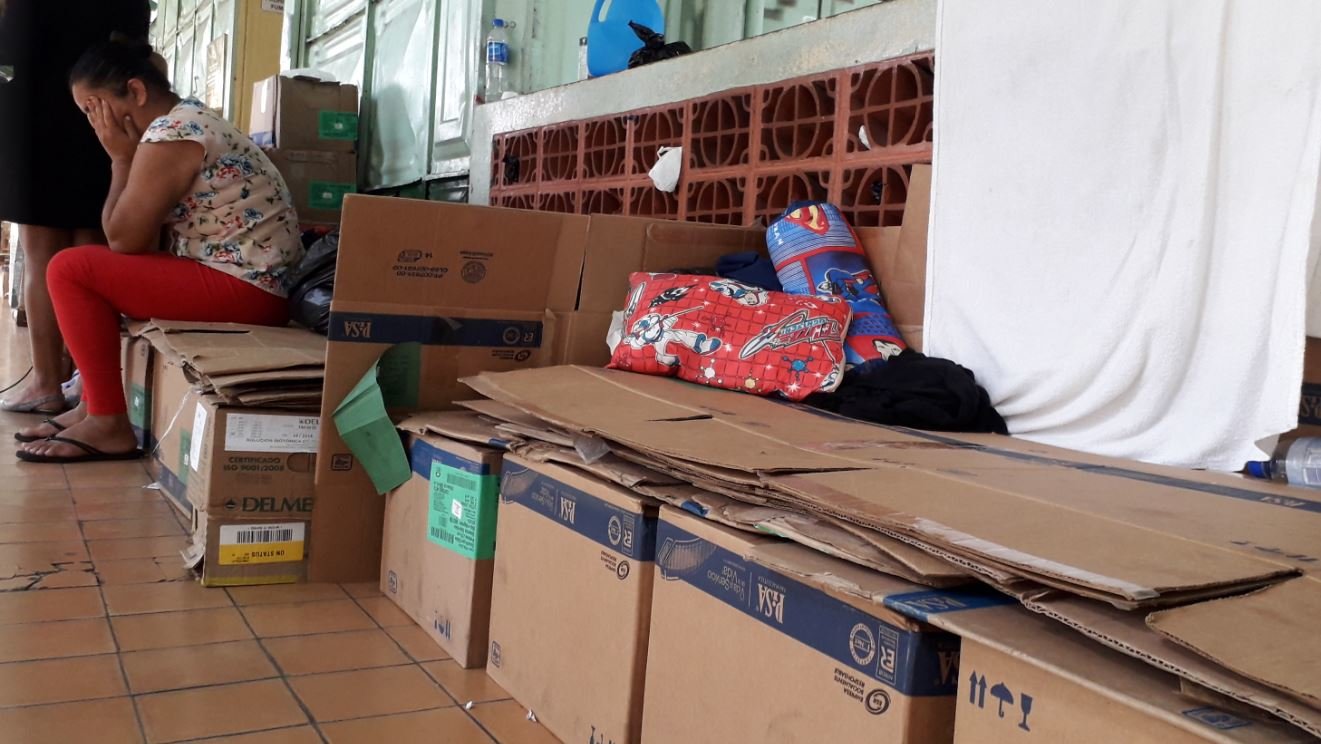 Familiares de pacientes duermen sobre cajas de cartón.